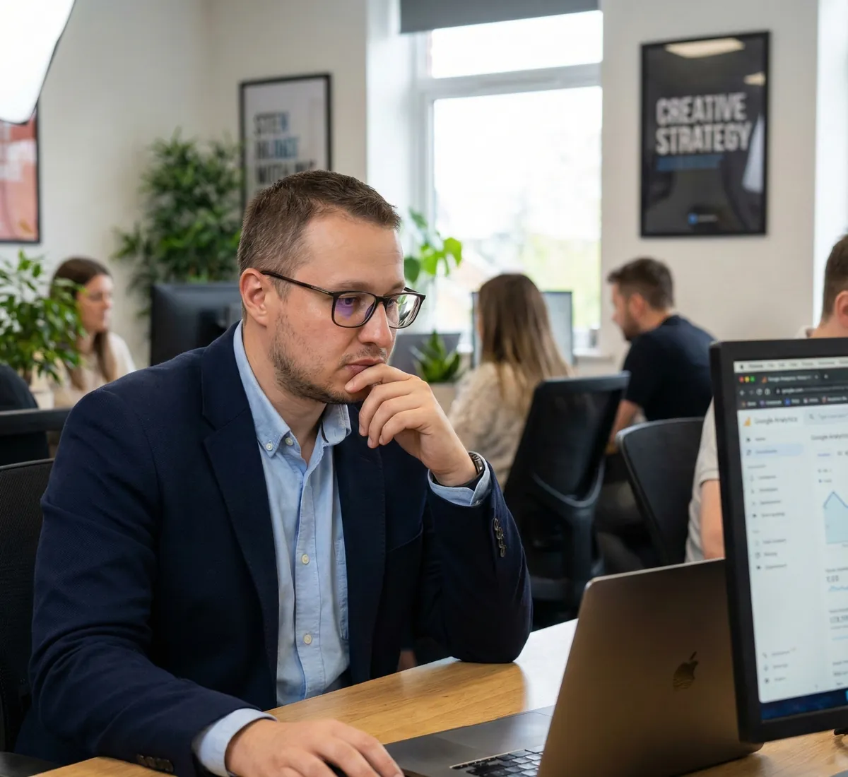 Ihor Lavrenenko, founder of Rathly, studying a client analytics dashboard at his desk in the Dallas office